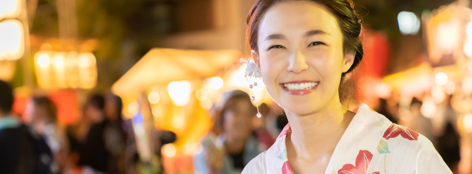 浴衣を着てお祭りデートを楽しんでいる女性